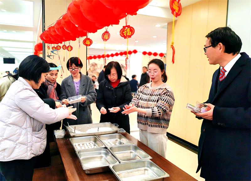 员工们兴致勃勃地穿梭在灯笼和灯谜之间
